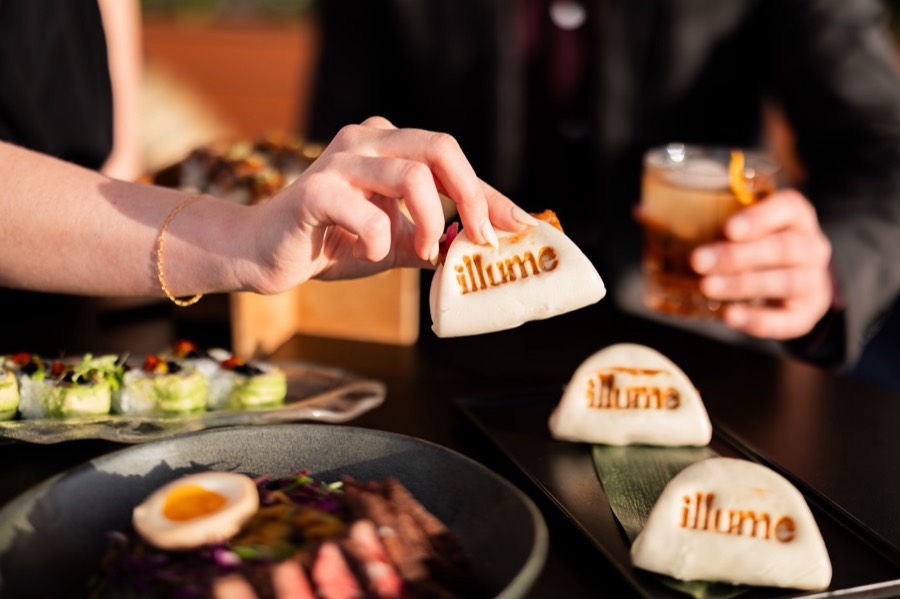 Branded bao and plates at illume Rooftop Lounge