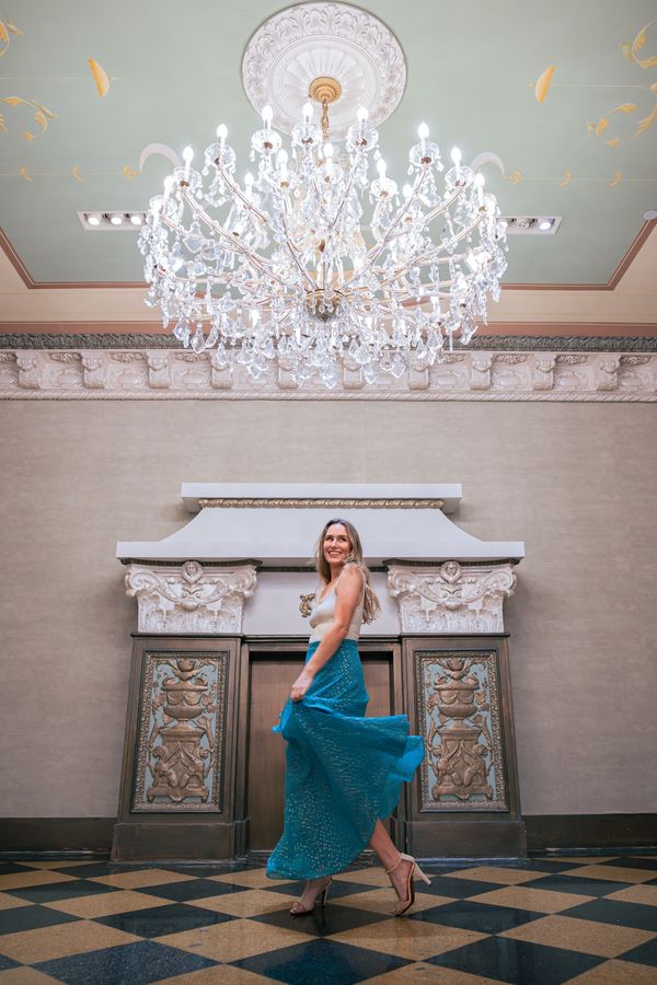 Guest twirling beneath a crystal chandelier at The US Grant